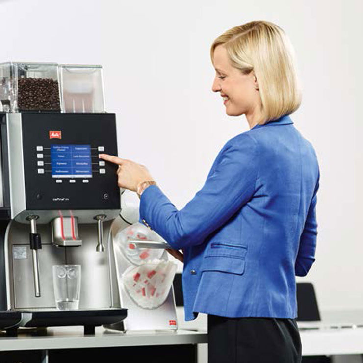 Lady using the buttons on Melitta Cafina XT4 Bean To Cup Coffee Machine