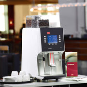 Melitta Cafina XT4 Bean To Cup Coffee Machine on a countertop at a hotel